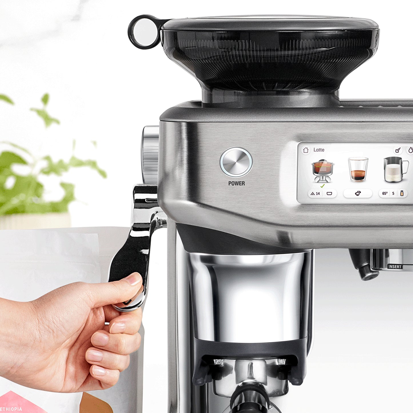 Image of the Sage Barista Touch Impress espresso machine, featuring its automatic tamping system.